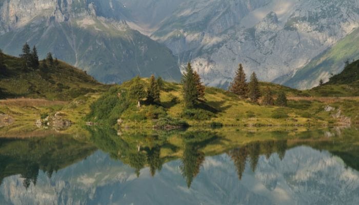 Embarking on a picturesque Buiräbähnli Safari Hike in Engelberg, Switzerland, surrounded by serene landscapes and charming trails