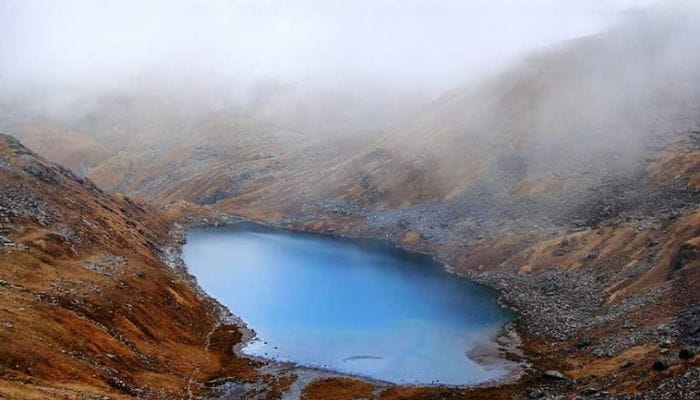 Vasuki Tal, a stunning high-altitude lake surrounded by snow-capped peaks and serene wilderness