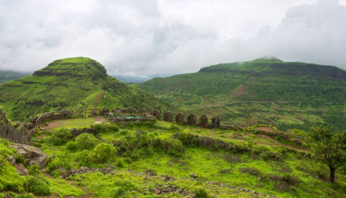 Hatgad Fort Trek - A mesmerizing view of the Hatgad Fort trail, surrounded by lush greenery and offering a glimpse of the historic fortification