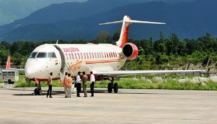 Aerial view of Jolly Grant Airport in Dehradun, the gateway to Kedarnath, nestled amidst greenery and surrounded by mountain