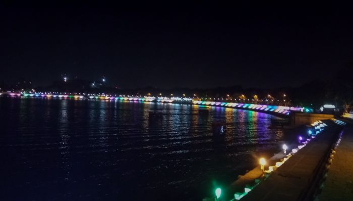Night view of Kankaria Lake in Ahmedabad, illuminated with colorful lights and reflections