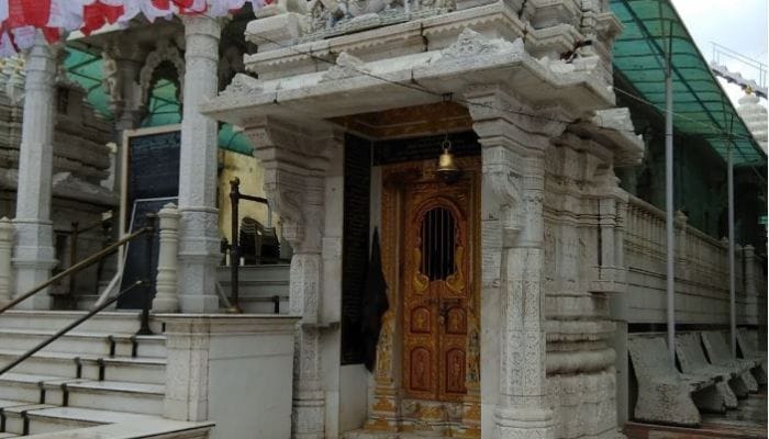 View of Shantinath Jain Derasar, emphasizing its ancient craftsmanship and serene atmosphere.