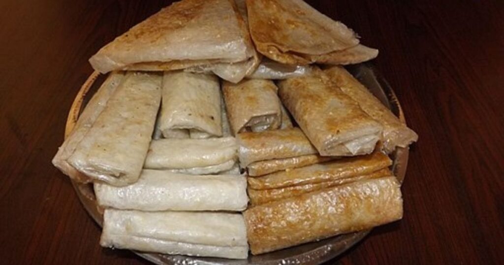 Paper-thin sheets of sweet rice starch rolled with jaggery/sugar and ghee, called Pootharekulu.